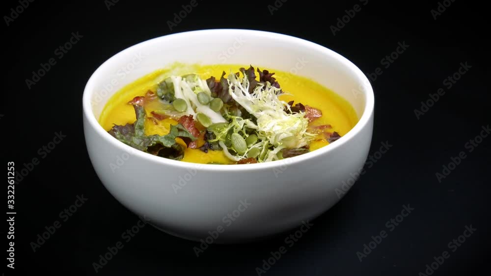 Delicious pea soup puree seasoned with salad and pumpkin seeds. Delicious pea soup puree seasoned with salad and pumpkin seeds.