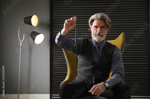 Obraz na płótnie Psychotherapist with pendulum in office. Hypnotherapy session