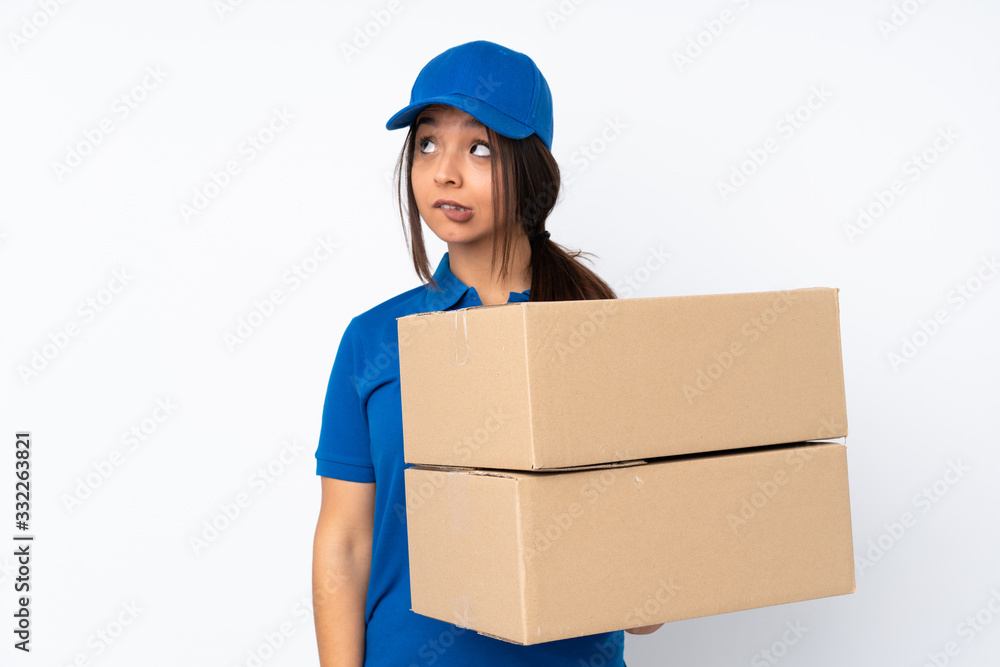 Young delivery brunette girl over isolated white background with confuse face expression Young delivery brunette girl over isolated white background with confuse face expression