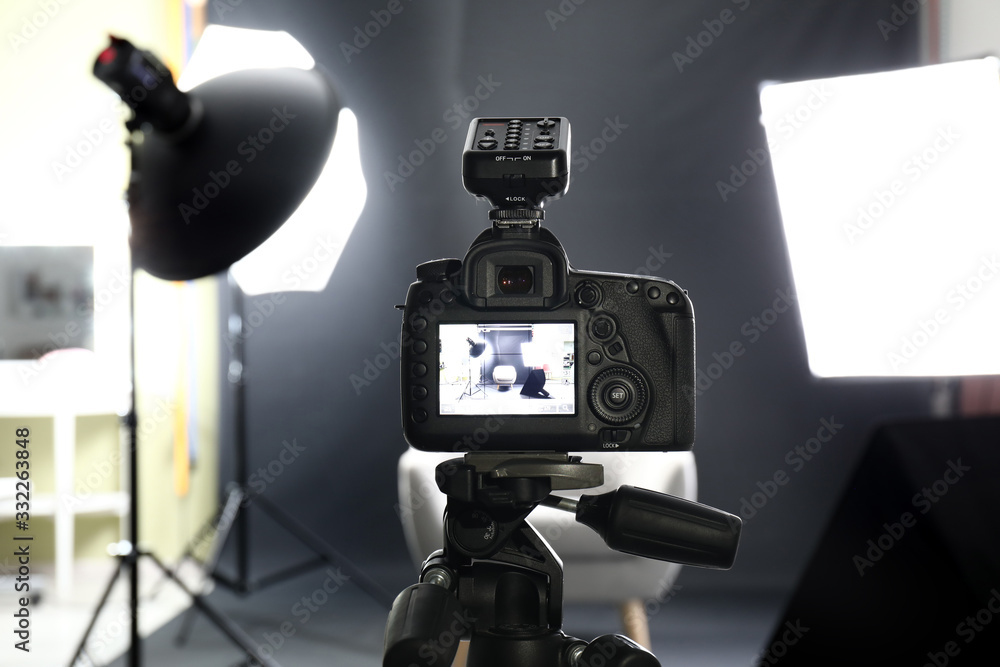 Professional camera on tripod in modern photo studio - obrazy, fototapety, plakaty 