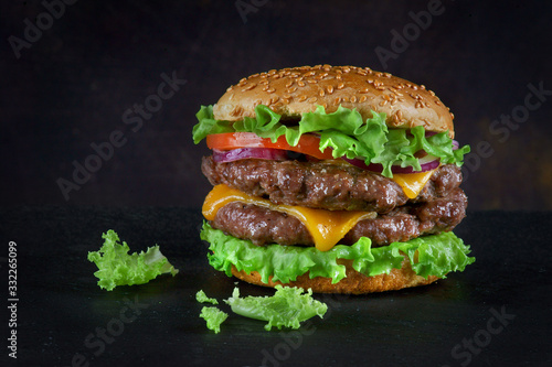 Burger with two beef patties and cheese on a dark background