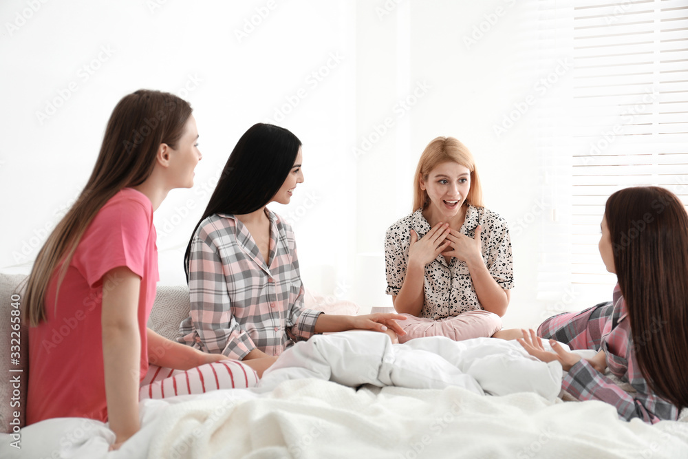 Beautiful young ladies on bed at pamper party. Women's Day Beautiful young ladies on bed at pamper party. Women's Day