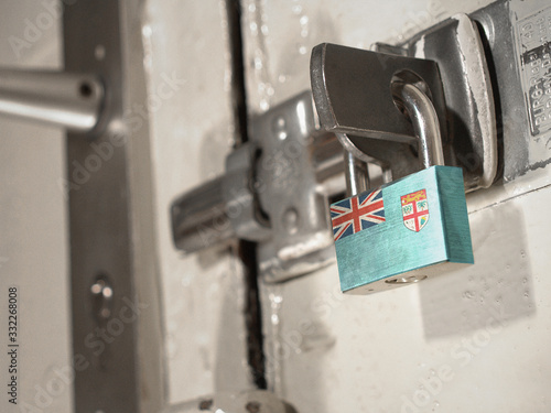 A bolted door secured by a padlock with the national flag of Fiji on it.(series)