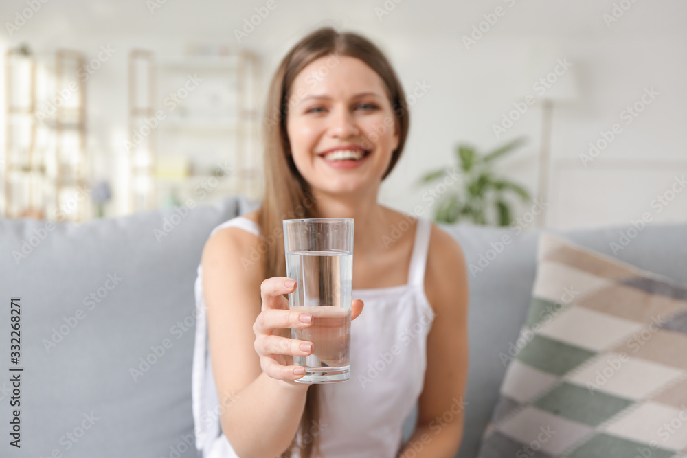 Beautiful young woman drinking water at home Beautiful young woman drinking water at home