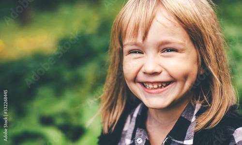 Portrait of a happy smiling child girl. Laughing child.