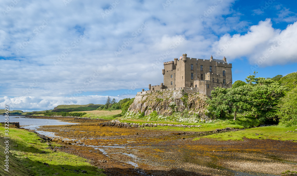 Landscape of Dunvegan Castle and Gardens at low tide. Travel destinations of Scotland.