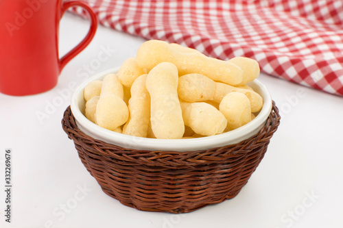 Traditional Brazilian starch biscuit called biscoito de polvilho in a basket in a white background coffe table photo