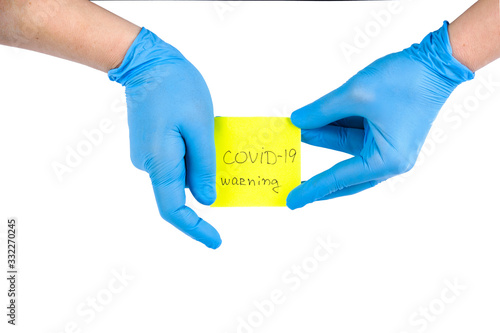 Hand with medical protective gloves and note covid-19. Cancellation flight and travel warning concept. Keep calm and fight the virus.Stay at home.