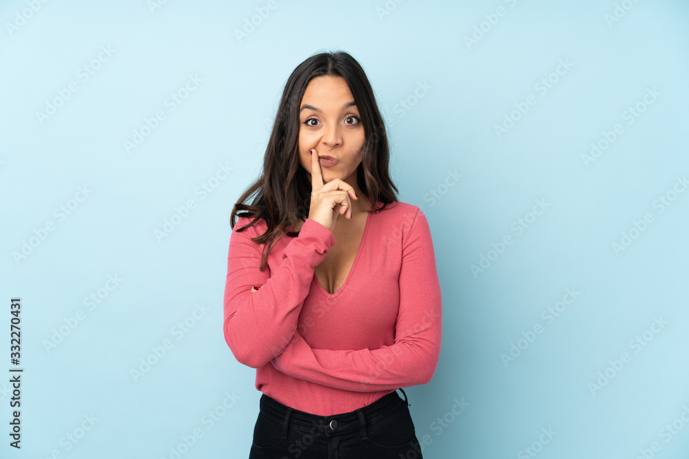 Young mixed race woman isolated on blue background and looking front Young mixed race woman isolated on blue background and looking front