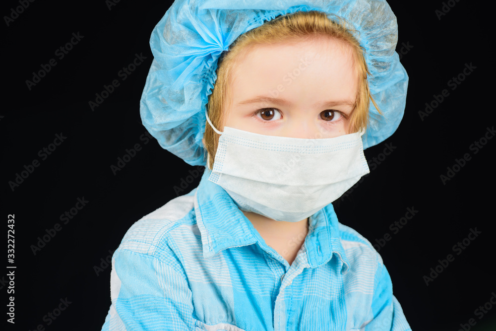 Facial hygienic mask from virus spread. Children's health concept. Little boy doctor with mask. Little boy doctor in protect mask. Coronavirus epidemic concept. Pandemic COVID-19. Kid in medical mask. Facial hygienic mask from virus spread. Children's health concept. Little boy doctor with mask. Little boy doctor in protect mask. Coronavirus epidemic concept. Pandemic COVID-19. Kid in medical mask.