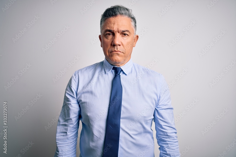 Middle age handsome grey-haired business man wearing elegant shirt and tie Relaxed with serious expression on face. Simple and natural looking at the camera. Middle age handsome grey-haired business man wearing elegant shirt and tie Relaxed with serious expression on face. Simple and natural looking at the camera.