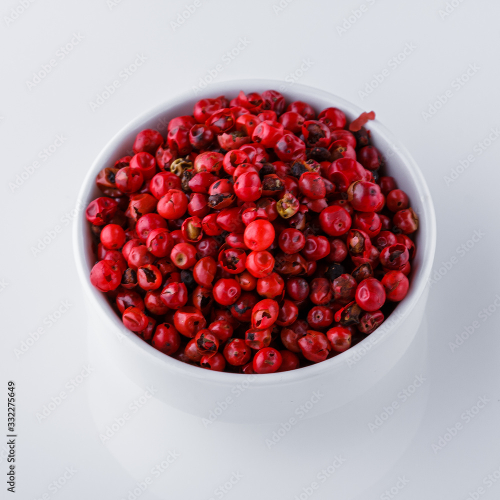 fragrant pink peppercorns on white acrylic background fragrant pink peppercorns on white acrylic background