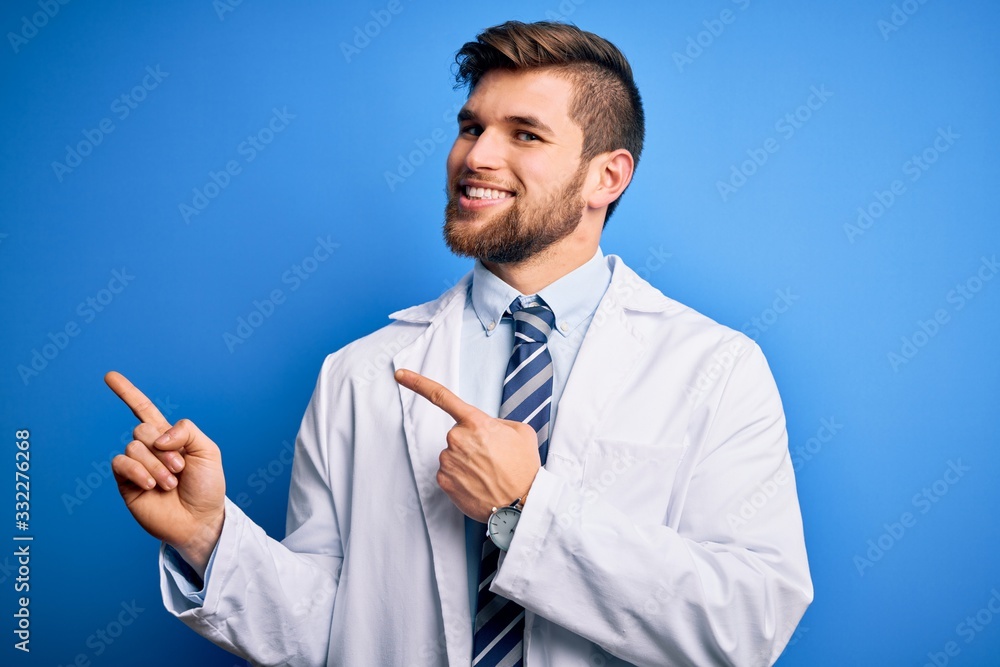 Young blond therapist man with beard and blue eyes wearing coat and tie over background smiling and looking at the camera pointing with two hands and fingers to the side. Young blond therapist man with beard and blue eyes wearing coat and tie over background smiling and looking at the camera pointing with two hands and fingers to the side.