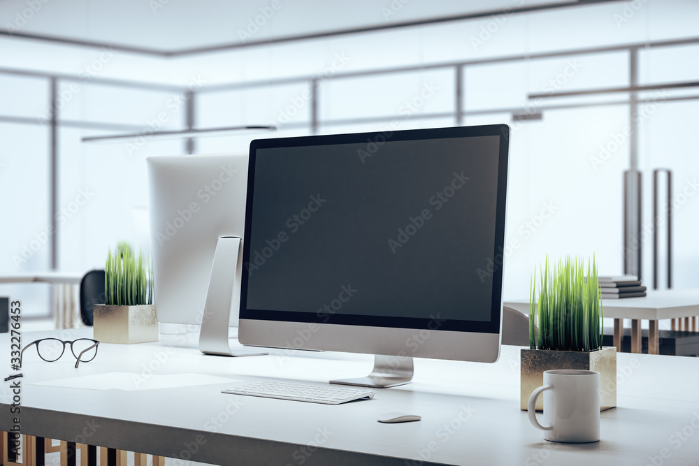 Coworking office and computer with blank screen Coworking office and computer with blank screen