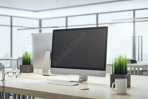 Computer on designer workplace with blank screen