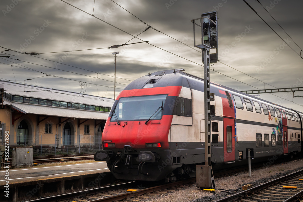 Fototapeta premium Red train on a train station in Konstanz, town in Germany