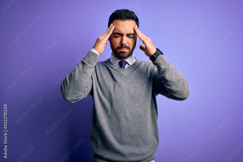 Handsome businessman with beard wearing casual tie standing over purple background with hand on head for pain in head because stress. Suffering migraine. Handsome businessman with beard wearing casual tie standing over purple background with hand on head for pain in head because stress. Suffering migraine.