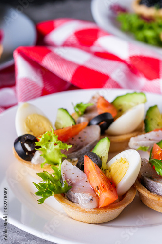 delicious snack tartlets on dark stone background