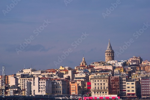 Galata Tower over the skyline of Istanbul, Turkey, on a sunny afternoon.