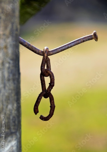 an old piece of chain hanging from a nail