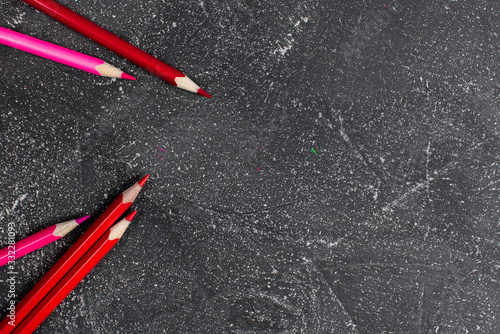 Red pencils on a black stone table