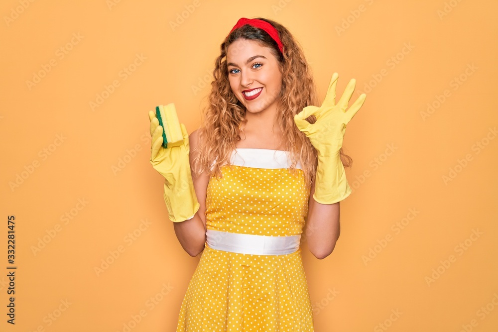 Young beautiful blonde woman with blue eyes cleaning using gloves and cleaner scourer doing ok sign with fingers, excellent symbol Young beautiful blonde woman with blue eyes cleaning using gloves and cleaner scourer doing ok sign with fingers, excellent symbol