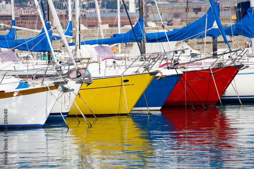 Detail of beautiful colored boats reflected in the water.