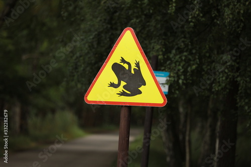 Information sign in Germany Attention toads cross the street. selective focus,