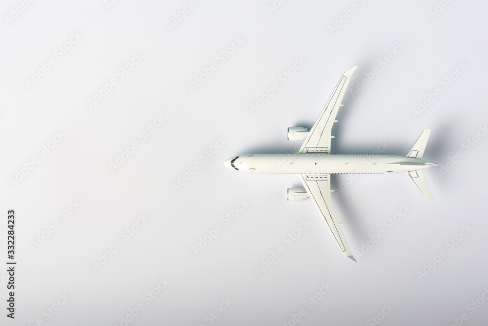 Travel concept. Top view of Jet airliner on white background with copy space. Online flight purchase, flight tickets booking Travel concept. Top view of Jet airliner on white background with copy space. Online flight purchase, flight tickets booking