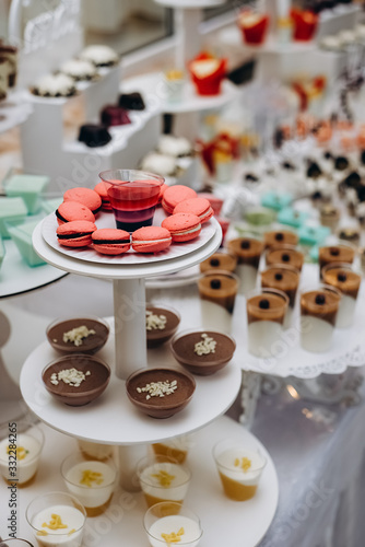 Candy bar with a lot of different candies, sweet cakes delicious cupcakes, cake pops, biscuits. Selective focus. Party and holiday celebration concept