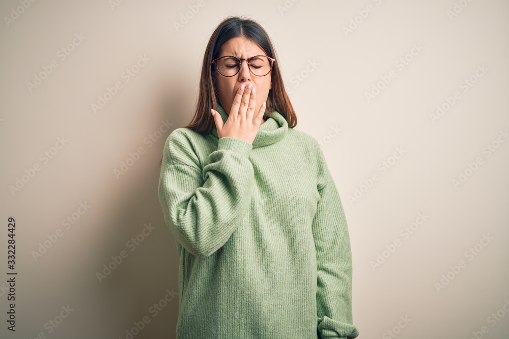 Young beautiful woman wearing casual sweater standing over isolated white background bored yawning tired covering mouth with hand. Restless and sleepiness. Young beautiful woman wearing casual sweater standing over isolated white background bored yawning tired covering mouth with hand. Restless and sleepiness.