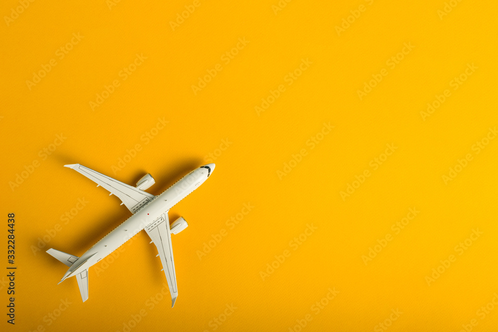 Travel concept. Top view of Jet airliner on yellow background with copy space. Online flight purchase, flight tickets booking Travel concept. Top view of Jet airliner on yellow background with copy space. Online flight purchase, flight tickets booking