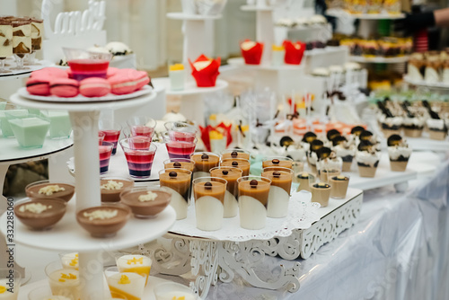 Candy bar with a lot of different candies, sweet cakes delicious cupcakes, cake pops, biscuits. Selective focus. Party and holiday celebration concept