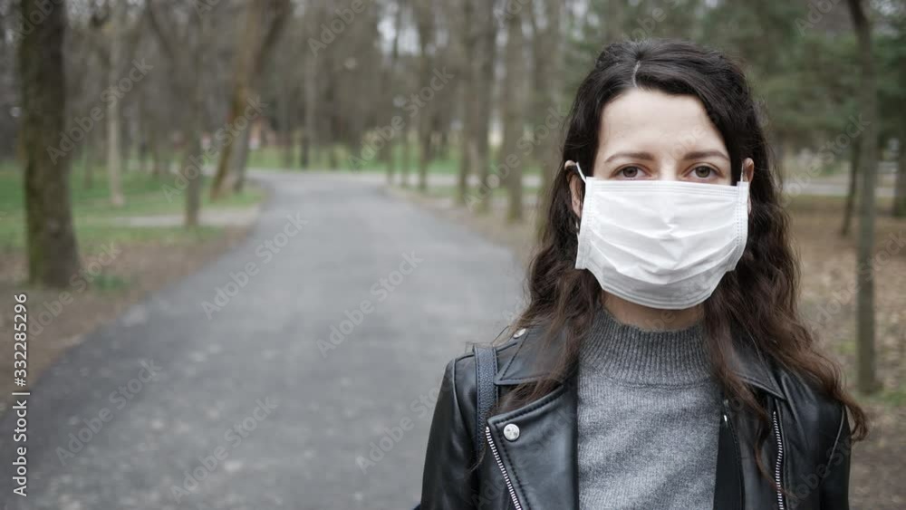 Young woman wears protective medical mask on face in midst of pandemic. copy space Young woman wears protective medical mask on face in midst of pandemic. copy space