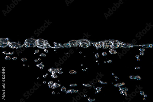 water waves with beautiful bubbles on a black background.