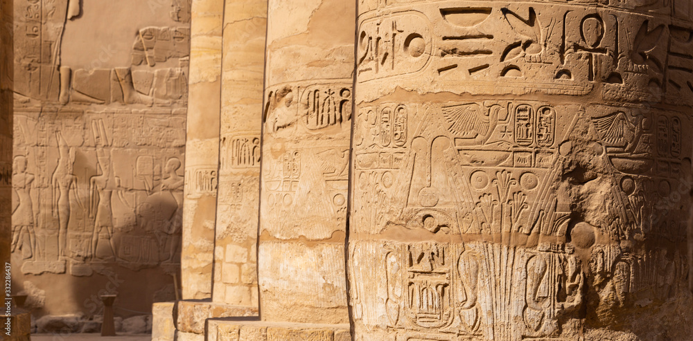 Karnak Temple, complex of Amun-Re. Great Hypostyle Hall. Embossed hieroglyphics on columns. Luxor Governorate, Egypt. Karnak Temple, complex of Amun-Re. Great Hypostyle Hall. Embossed hieroglyphics on columns. Luxor Governorate, Egypt.