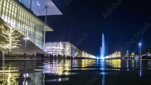 Athens, Greece - December 15, 2019: Night view of colourful dancing water fountain event at Stavros Niarchos Foundation Cultural Center (SNFCC) in Athens. Christmas decorations. Time Lapse. FullHD
