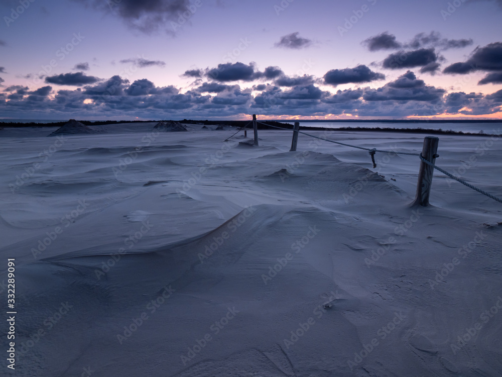 Sunrise on the moving dunes during windy morning. Leba, Poland Sunrise on the moving dunes during windy morning. Leba, Poland