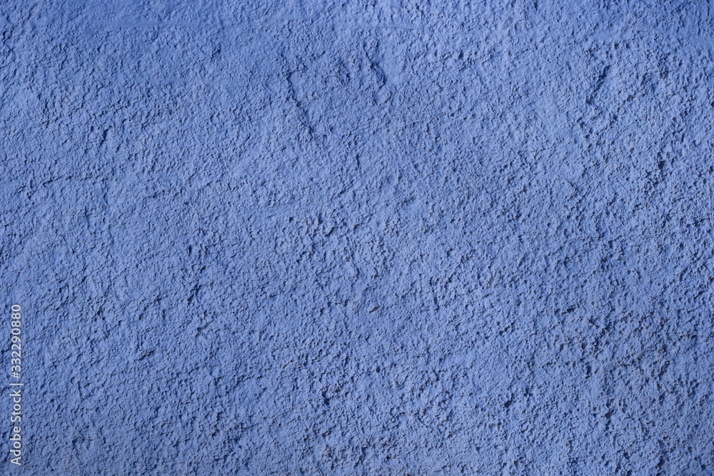 Decorative classic blue stucco on the wall, texture. Textured blue background. Classic blue wall texture Decorative classic blue stucco on the wall, texture. Textured blue background. Classic blue wall texture
