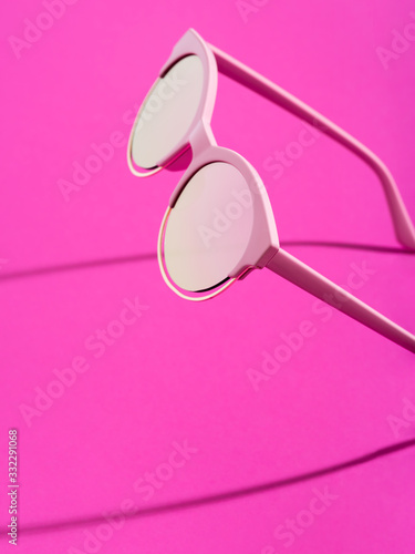 Fototapeta Pink sunglasses on fuchsia pink background