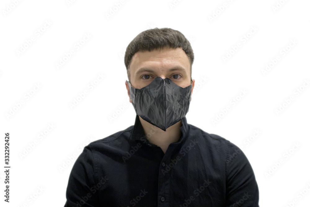 brunette man in a black shirt and a black mask on his face on a white background