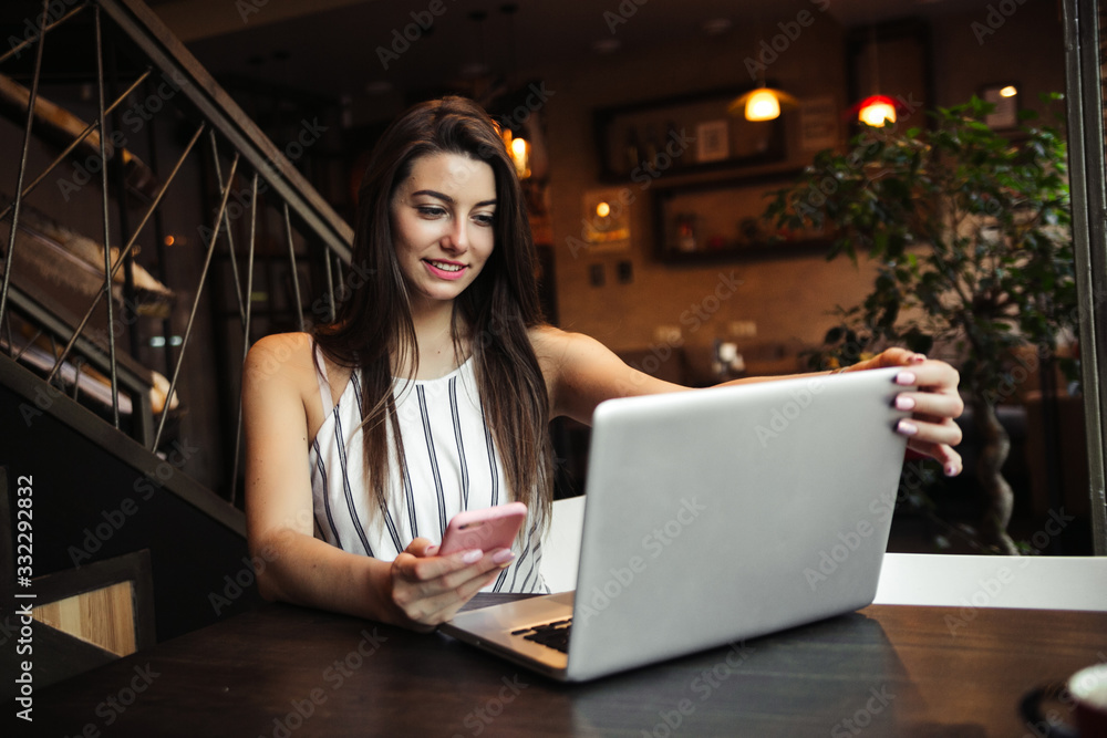 Young pretty caucasian woman in cafe in city centre with tablet laptop Young pretty caucasian woman in cafe in city centre with tablet laptop