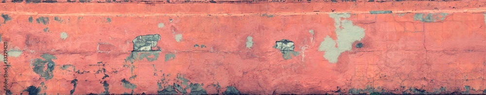 Sandstone pink wall with peeling paint, cracks, and dirt
