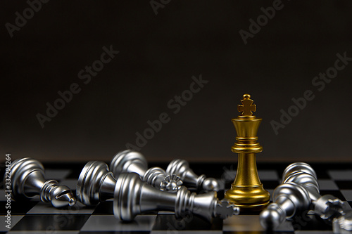 The king golden chess standing in the middle of the falling silver chess.Concepts of leadership and business strategy plans.