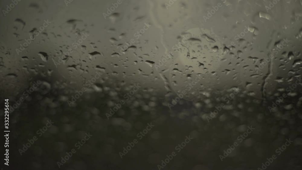 Close up of rainwater droplets on glass. Handheld Close up of rainwater droplets on glass. Handheld