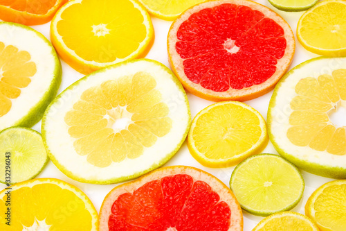 cut pieces of different citrus fruits on white background