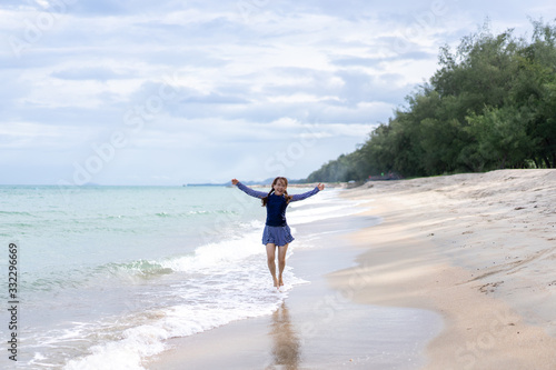 Middle age senior woman is Enjoying and running Summer Vacation on the beach, Thailand.