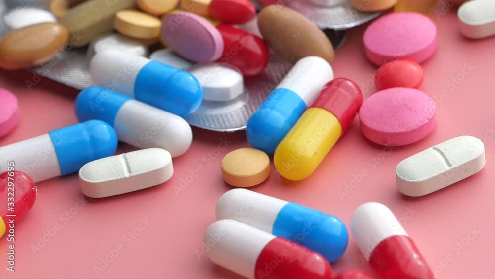 colorful pills spilling on blue background, top view colorful pills spilling on blue background, top view
