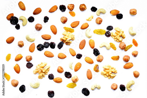 Fototapeta Naklejka Na Ścianę i Meble -  Mix of nuts - cobnut, cashew, almond core, Walnut and dry fruit – raisin on white background. The concept of healthy eating. Top view