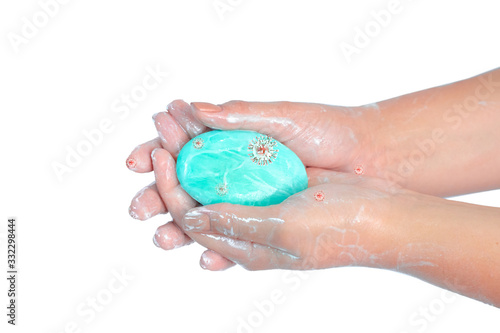 Close up of washing hands with soap with red corona virus isolated on white background. Coronavirus prevention hand hygiene. Corona Virus pandemic protection by cleaning hands frequently.